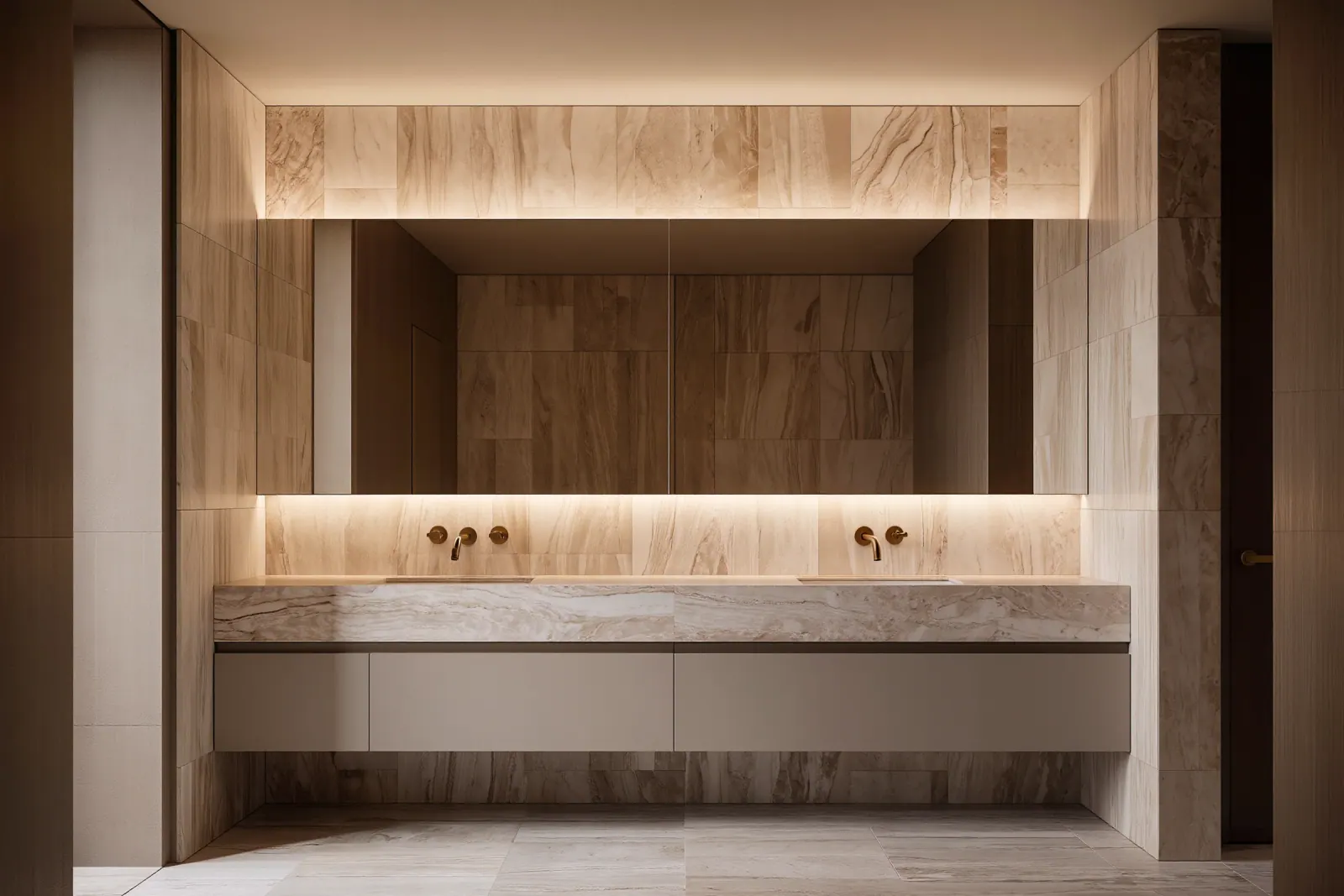 Warm minimalist bath in travertine with a floating double vanity and backlit mirror