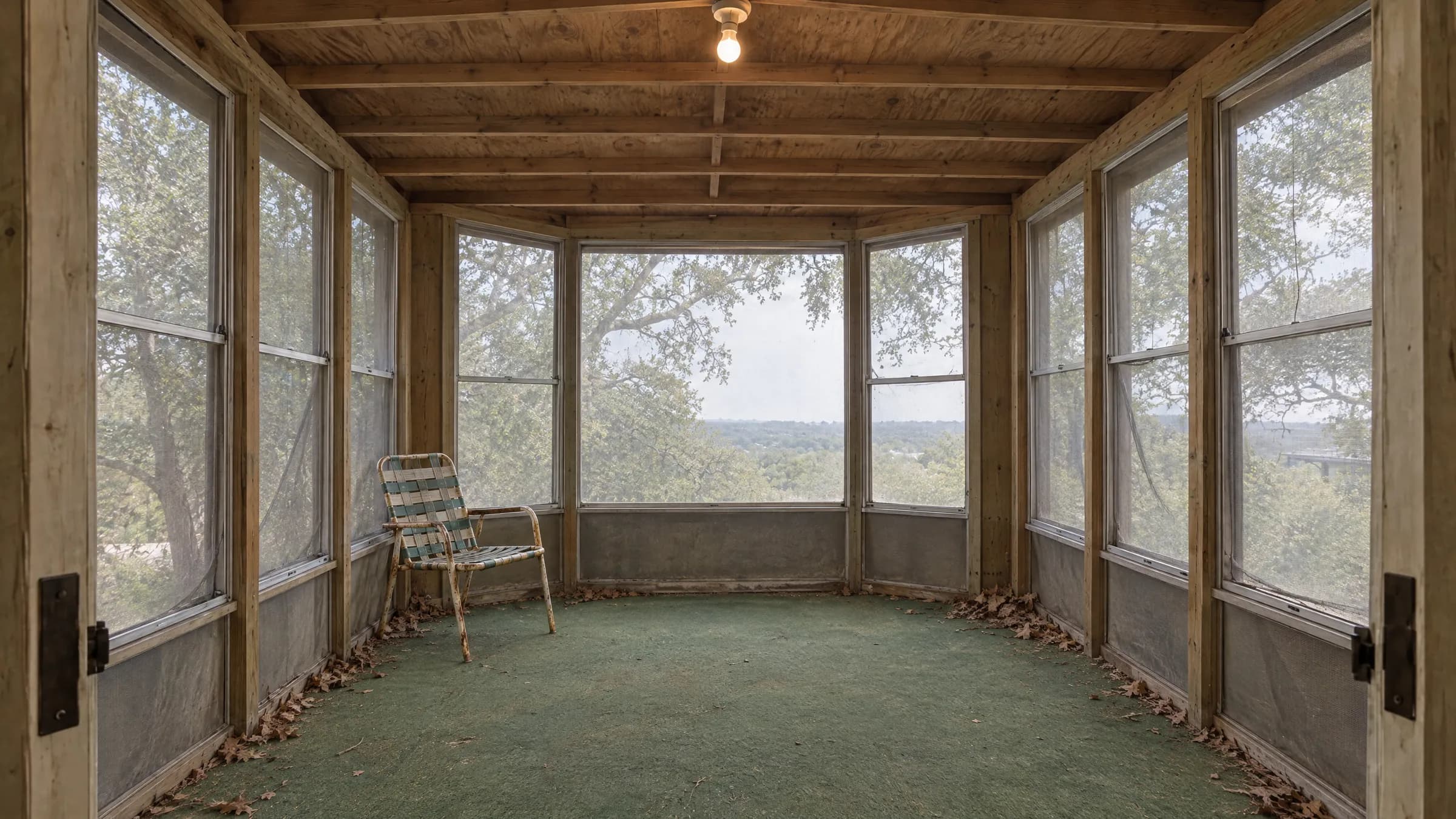 The same footprint before the addition, a sagging 1980s screened porch with indoor-outdoor carpet and exposed rafters