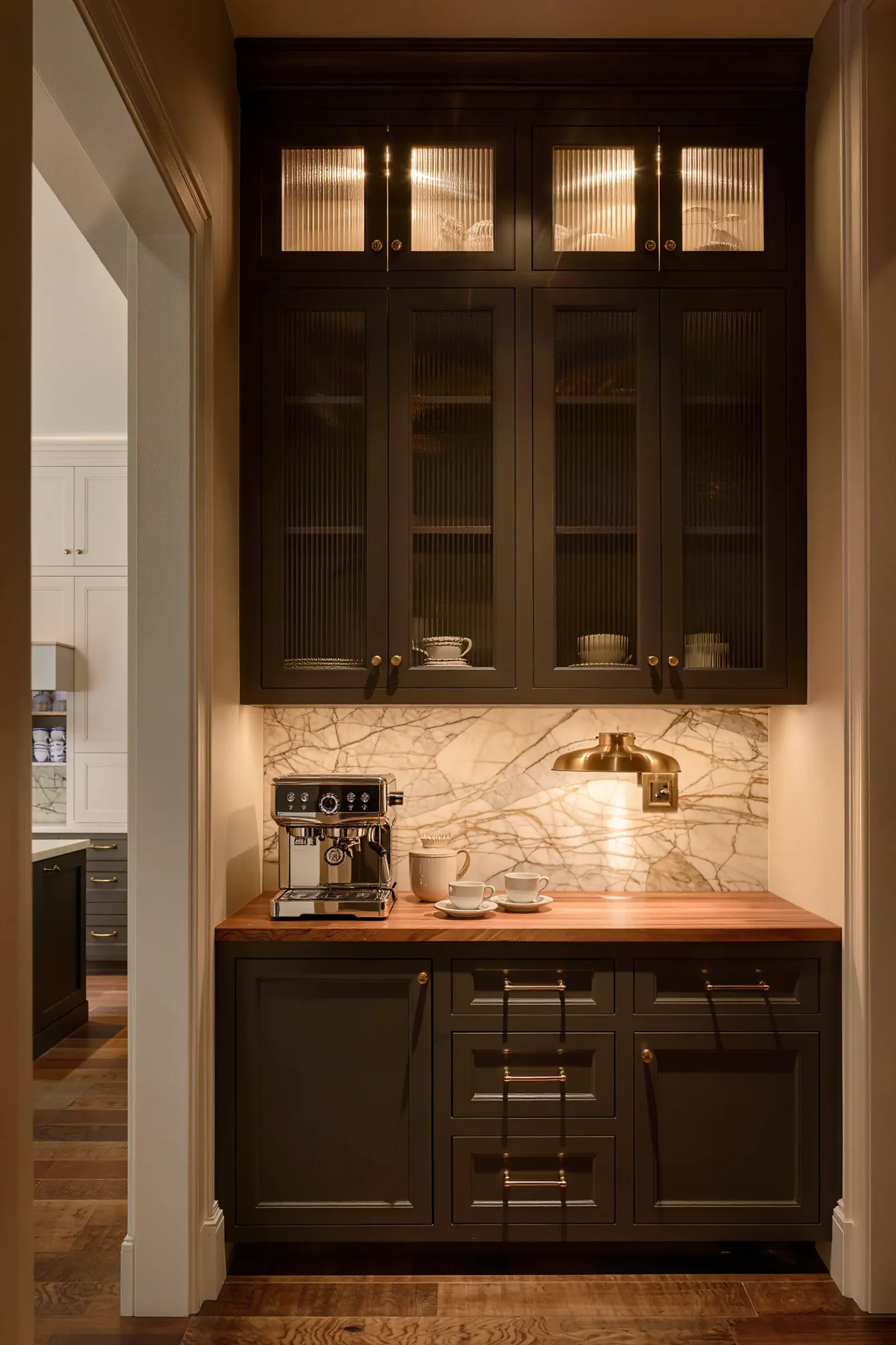 Butler's pantry and coffee bar with fluted glass doors, a walnut counter, and a brass sconce