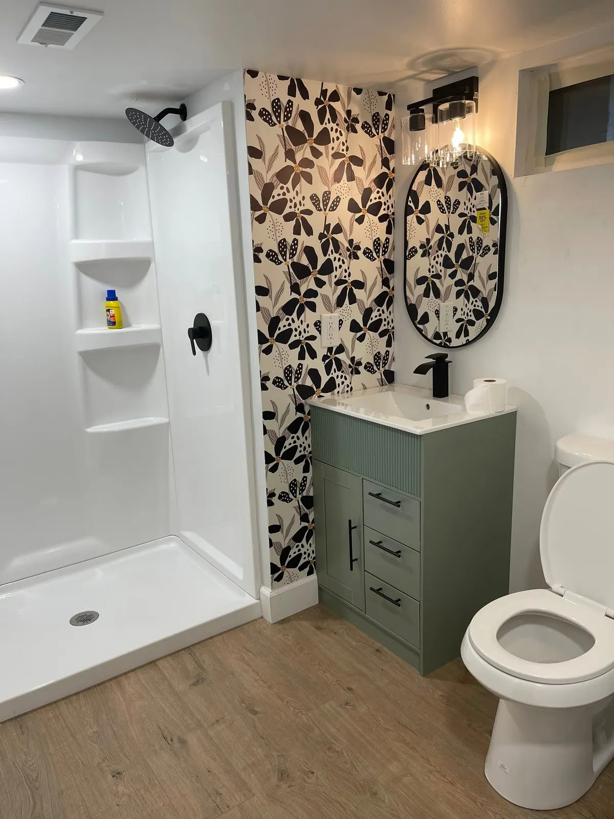 After: the shower with built-in niches beside the sage vanity