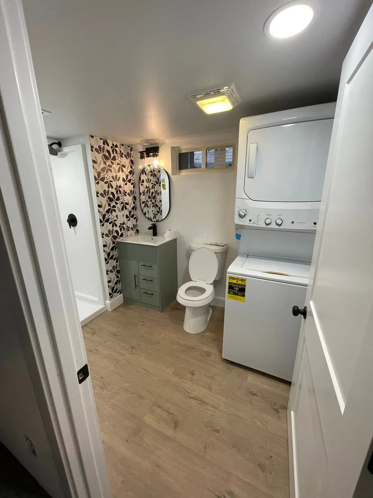 After: the bath from the doorway with the laundry tucked beside the toilet