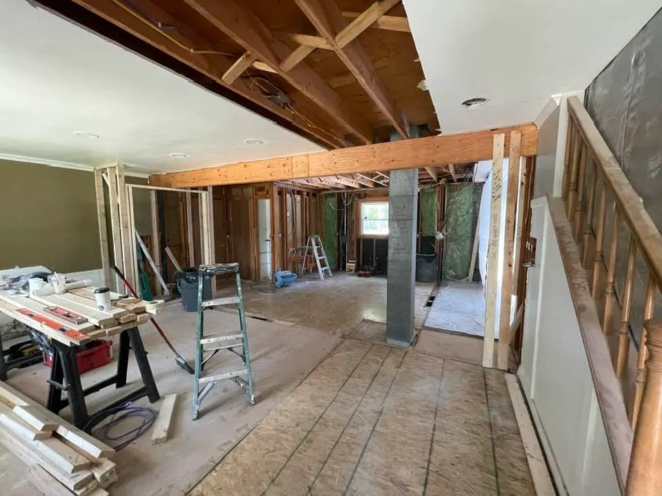 During demolition, with the wall framing opened and the ceiling exposed