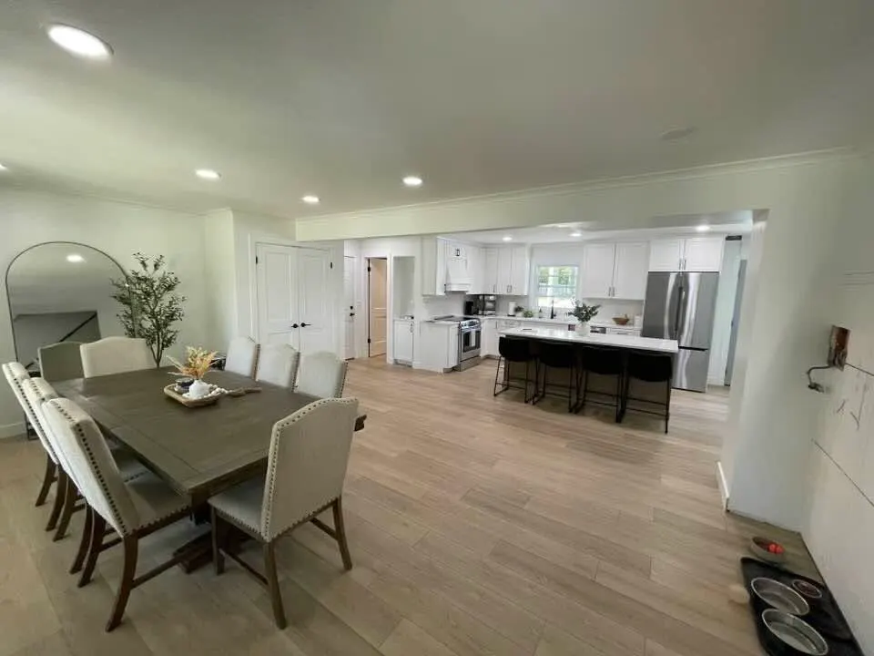 After: the dining table in the new open plan, with the kitchen island beyond