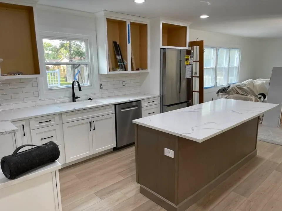 After: the quartz island with waterfall-free edge and a wood-tone base