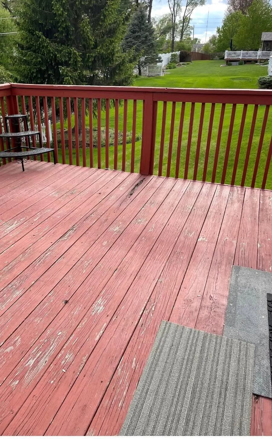 Before: the faded red deck boards and rail before demolition