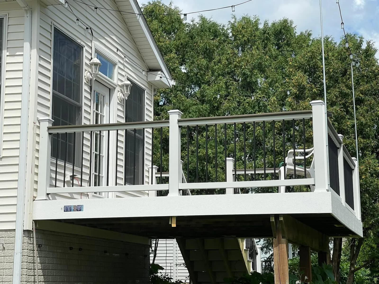 After: the white rail and post caps along the deck edge