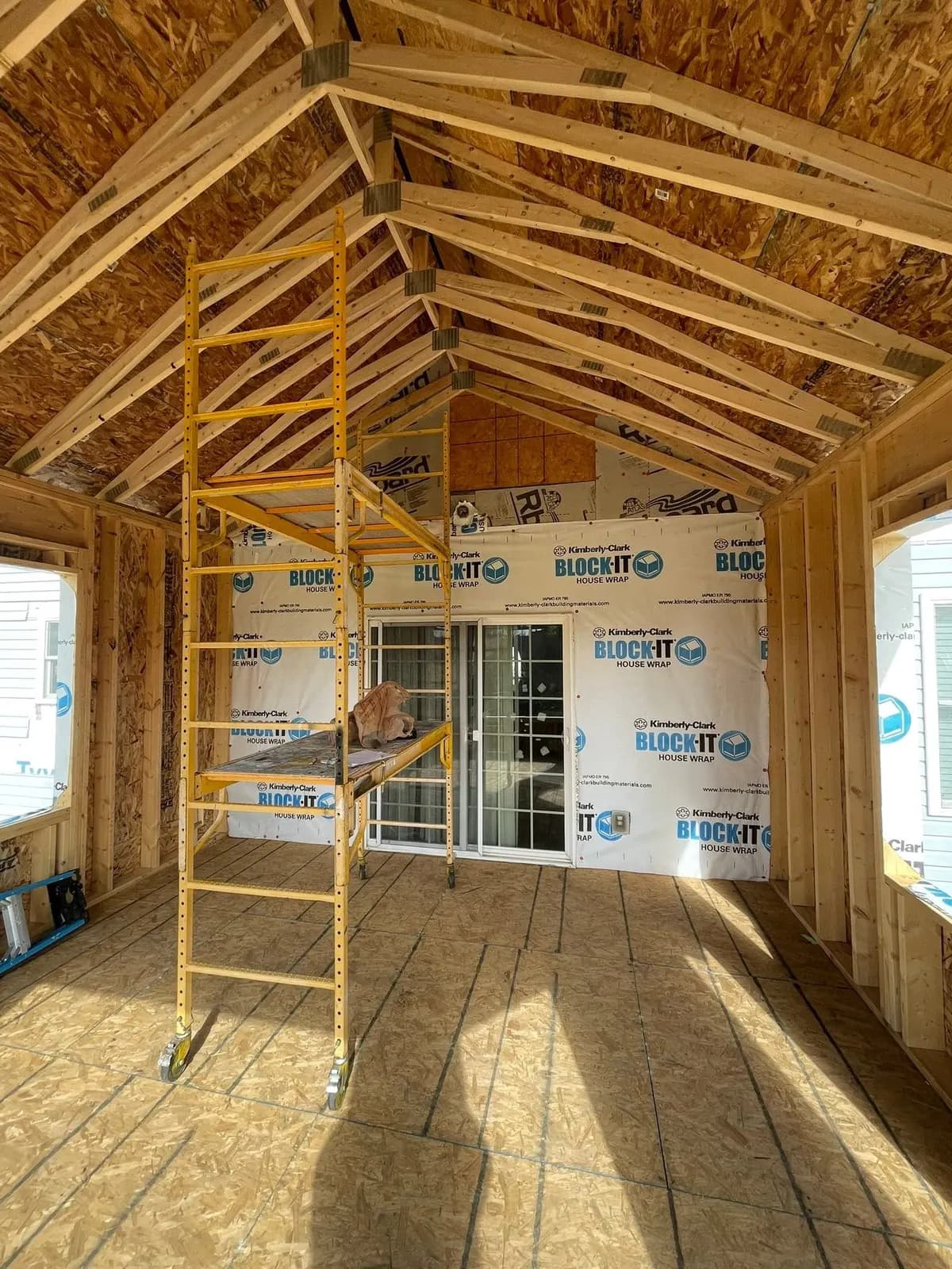Inside the framed addition with scaffolding set for the vaulted ceiling